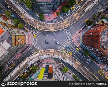 Aerial view of cars and trains with intersection or junction with traffic, Taipei Downtown, Taiwan. Financial district and business area. Smart urban city technology.
