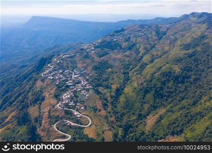 Aerial view of cars driving on curved, zigzag curve road or street on mountain hill with green natural forest trees in rural area of Phu Tub Berk, Phetchabun, Thailand.