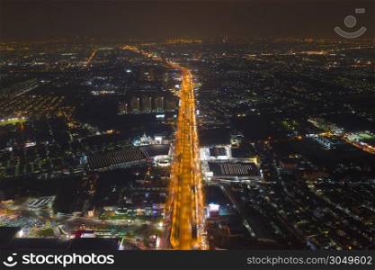 Aerial view of cars driving on highway junctions. Bridge roads shape number 8 or infinity sign in connection of architecture concept. Top view. Urban city, Bangkok at night, Thailand.