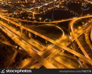 Aerial view of cars driving on highway junctions. Bridge roads shape number 8 or infinity sign in connection of architecture concept. Top view. Urban city, Taipei at night, Taiwan.