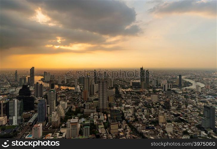 Aerial view of Chao Phraya River, Bangkok Downtown. Financial district and business centers in smart urban city in Asia. Skyscraper and high-rise buildings at sunset.
