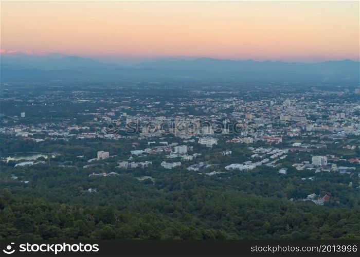 Aerial view of Chiang Mai Downtown Skyline, Thailand. Financial district and business centers in urban city in Asia. Skyscraper and high-rise buildings on mountain hill at sunset.