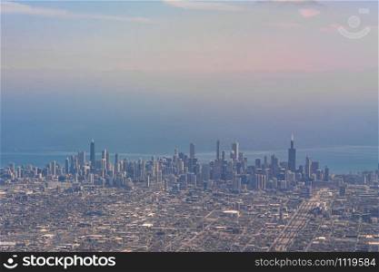 Aerial view of Chicago Cityscape river side at the afternoon time which look through airplane windows, Aircraft Wing, USA downtown skyline, Architecture and building with tourist concept,