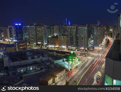 Aerial view of city lit up at night