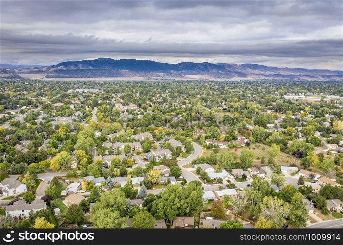 aerial view of city residential area in northern Colorado with foothills and Rocky Mountains in background, Fort Collins in early fall scenery