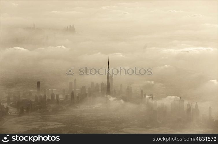 Aerial view of cityscape, dramatic sand storm in Dubai, beautiful city covered with clouds, windy weather in desert, United Arab Emirates