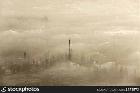 Aerial view of cityscape, dramatic sand storm in Dubai, beautiful city covered with clouds, windy weather in desert, United Arab Emirates