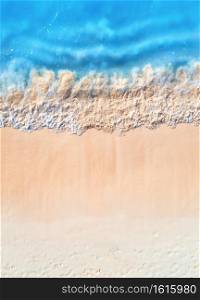 Aerial view of clear blue sea with waves and empty white sandy beach at sunset. Summer in Zanzibar, Africa. Tropical landscape with white sand and azure water. Ocean. Top view. Nature background