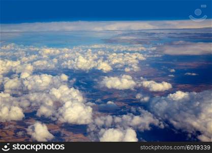 Aerial view of clouds and blue sky while flying on aircraft