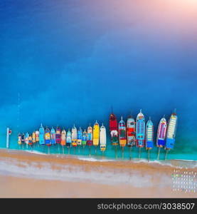 Aerial view of colorful boats in mediterranean sea in Oludeniz, Turkey. Beautiful summer seascape with ships, clear azure water and sandy beach at sunset. Top view of yachts from flying drone. Aerial view of colorful boats in mediterranean sea