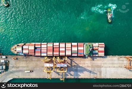 Aerial view of container ship in import - export business industry in Sriracha industrial port, Chonburi, Thailand.