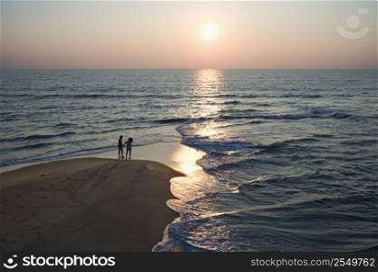 Aerial view of couple on beach in Bald Head Island, North Carolina during sunset.