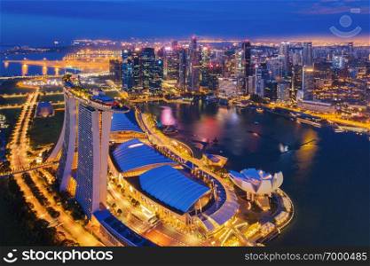 Aerial view of Downtown Singapore city in Marina Bay area. Financial district and skyscraper buildings at night