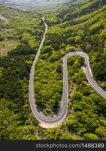 Aerial view of drone to road through mountain with bends