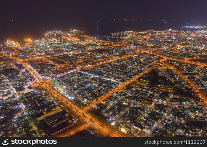 Aerial view of Dubai Downtown, highway roads or street in United Arab Emirates or UAE. Financial district and business area in smart urban city. Skyscraper and high-rise buildings at night.