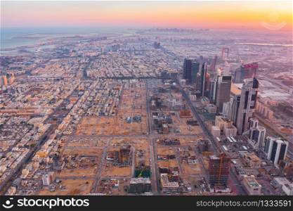 Aerial view of Dubai Downtown skyline, United Arab Emirates or UAE. Financial district and business area in smart urban city. Skyscraper and high-rise buildings at sunset.
