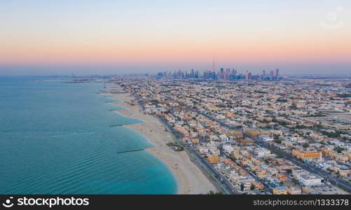 Aerial view of Dubai sea coast beach with downtown skyline, bay in United Arab Emirates or UAE. Financial district and business area in smart urban city. Skyscraper and high-rise buildings.