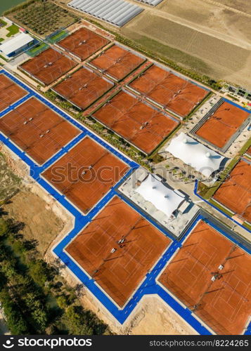 Aerial view of empty clay tennis court on a sunny day