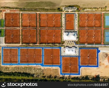 Aerial view of empty clay tennis court on a sunny day
