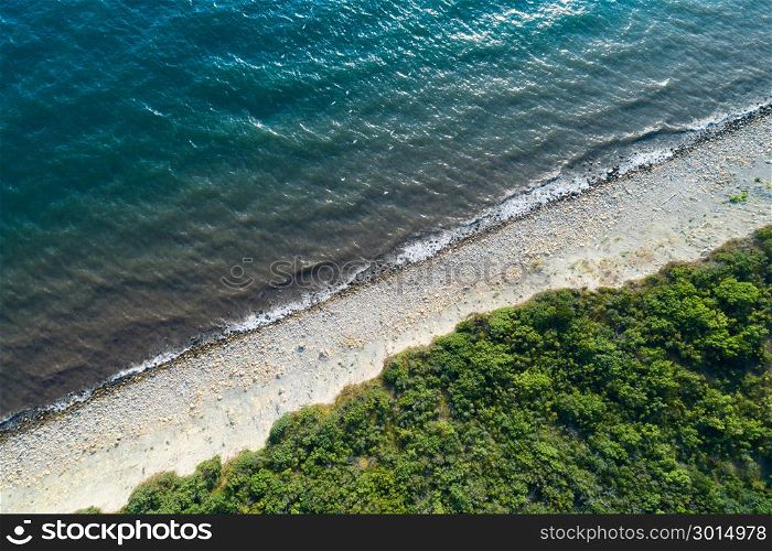 Aerial view of empty seashore. Diadonal line of surf.