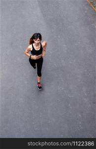 Aerial view of female athlete running on a road