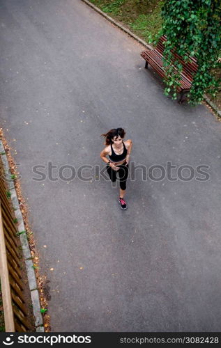 Aerial view of female athlete running on a road