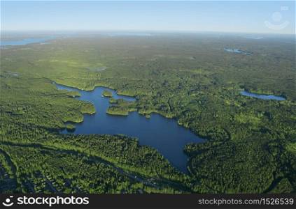Aerial view of Finnish blue lakes and green forests district . Forest and lakes