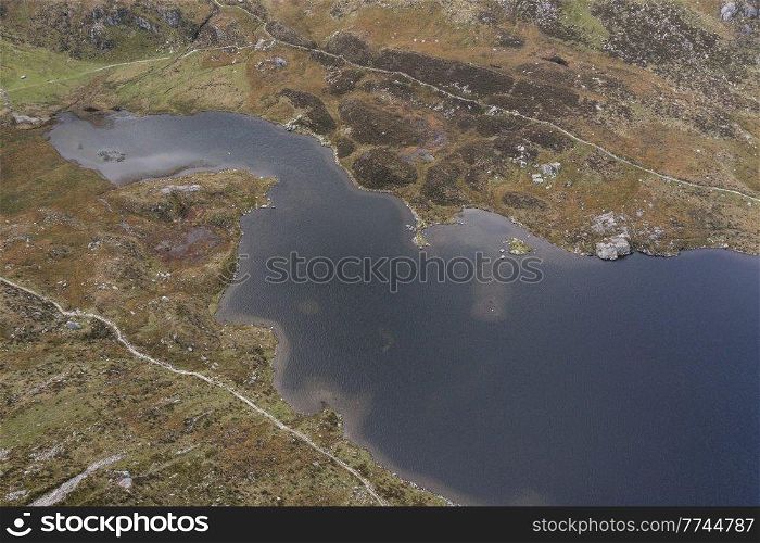 Aerial view of flying drone Epic stunning Autumn landscape image of Llyn Idwal in Devil&rsquo;s Kitchen in Snowdonia National Park with gorgeous light