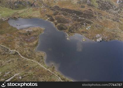 Aerial view of flying drone Epic stunning Autumn landscape image of Llyn Idwal in Devil&rsquo;s Kitchen in Snowdonia National Park with gorgeous light