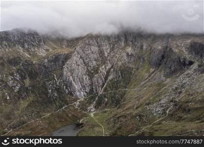 Aerial view of flying drone Epic stunning Autumn landscape image of Llyn Idwal in Devil’s Kitchen in Snowdonia National Park with gorgeous light