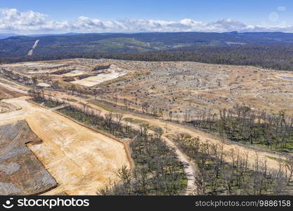 Aerial view of forest regeneration after bushfires and a new sand quarry being built in regional Australia