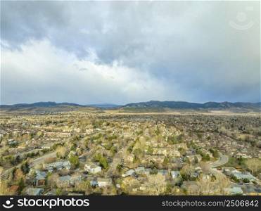 aerial view of Fort Collins and foothills of Rocky Mountains in northern Colorado, early spring scenery with stormy clouds