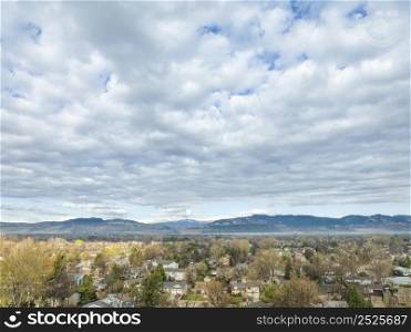 aerial view of Fort Collins and foothills of Rocky Mountains in northern Colorado, early spring scenery with dramatic clouds
