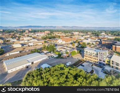 aerial view of Fort Collins downtown with Front Range of Rocky Mountains on horizon, late summer