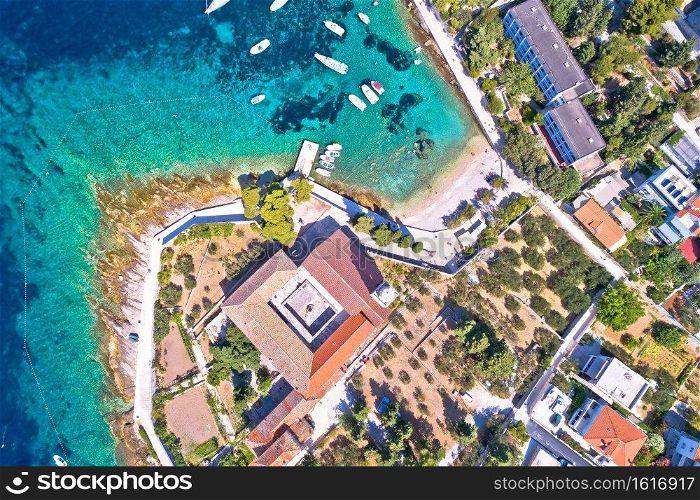 Aerial view of Franciscan monastery and amazing turquoise beach in town of Hvar, Dalmatia archipelago of Croatia