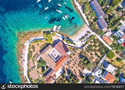 Aerial view of Franciscan monastery and amazing turquoise beach in town of Hvar, Dalmatia archipelago of Croatia