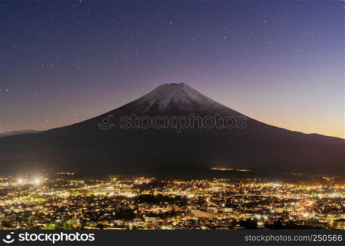 Aerial view of Fuji mountain at night with stars in Fujikawaguchiko, Yamanashi. Urban city, Japan. Landscape with architecture buildings
