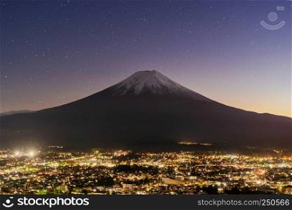 Aerial view of Fuji mountain at night with stars in Fujikawaguchiko, Yamanashi. Urban city, Japan. Landscape with architecture buildings