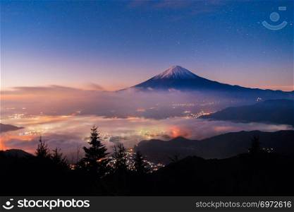Aerial view of Fuji mountain with mist or fog at sunrise in Fujikawaguchiko, Yamanashi. Fuji five lakes, Japan. Landscape with hills