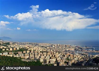 Aerial view of Genova, Italy, with bright white clouds over blue sky