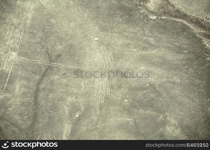 Aerial view of geoglyphs near Nazca - famous Nazca Lines, Peru. In the center, Hummingbird figure is present