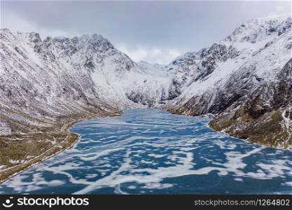 Aerial view of Glacier. Ice lake in Lofoten islands, Nordland county, Norway, Europe. White snowy mountain hills and trees, nature landscape background in winter season. Famous tourist attraction