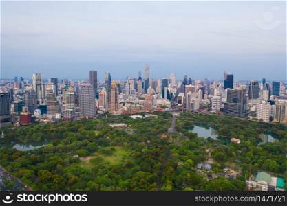 Aerial view of green trees in Lumpini Park, Sathorn district, Bangkok Downtown Skyline. Thailand. Financial district and business center in smart urban city in Asia. Skyscraper and high-rise buildings