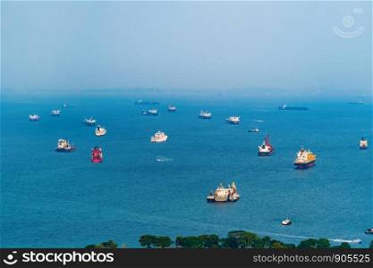 Aerial view of group of boats in sea near Singapore beach with blue sky for travel and transportation background.