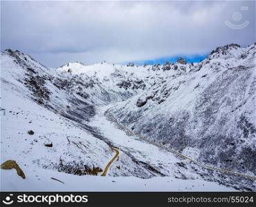 Aerial view of highway at the valley of snow mountain in Sichuan China