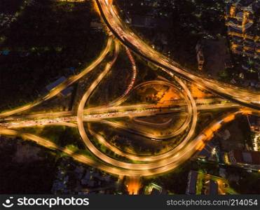 Aerial view of highway junctions. Bridge roads shape circle in structure of architecture concept. Top view. Urban city, Bangkok at night, Thailand.