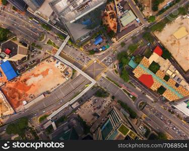 Aerial view of highway junctions shape letter x cross at sunset. Bridges, roads, or streets in transportation concept. Structure shapes of architecture in urban city, Kuala Lumpur Downtown, Malaysia