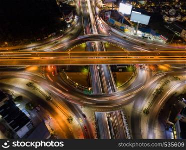 Aerial view of highway junctions with roundabout. Bridge roads shape circle in structure of architecture and transportation concept. Top view. Urban city, Bangkok at night, Thailand.