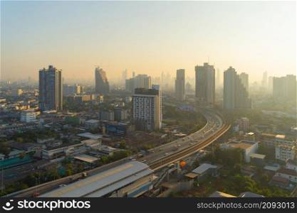 Aerial view of highway street road at Bangkok Downtown Skyline, Thailand. Financial district and business centers in smart urban city in Asia.Skyscraper and high-rise buildings at sunset
