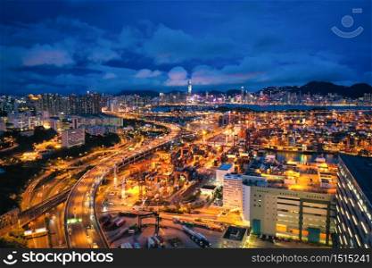 Aerial view of Hong Kong City with container port terminal at dramatic sky in Hong Kong.